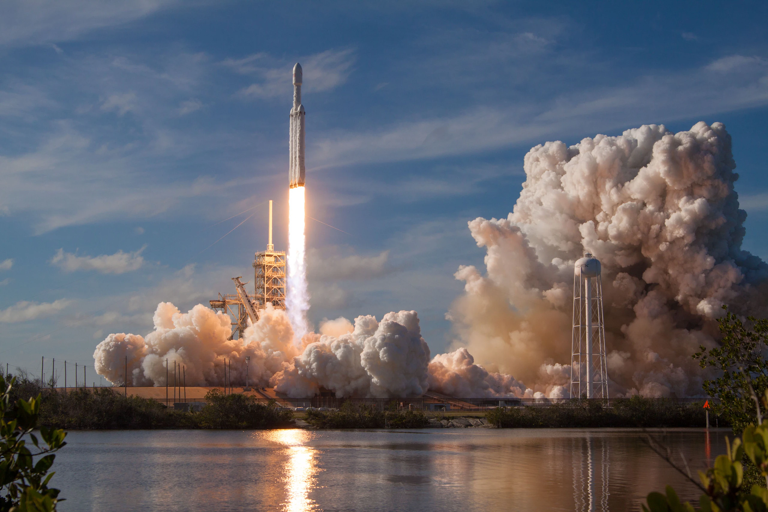 Falcon 9 lifting off in a cloud of smoke and fire